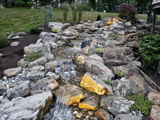 Landscape lighting and a water feature in a Maryland garden