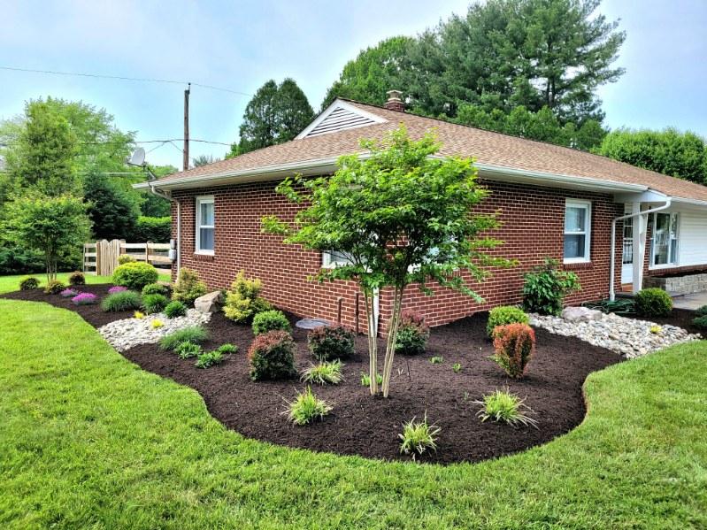 Stone walkway bordered by mixed plantings