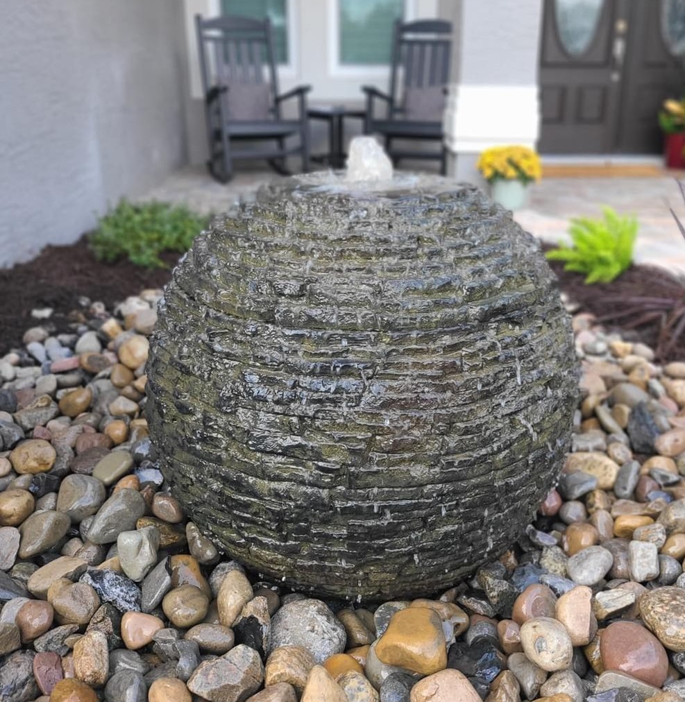 Tiered garden fountain surrounded by planting