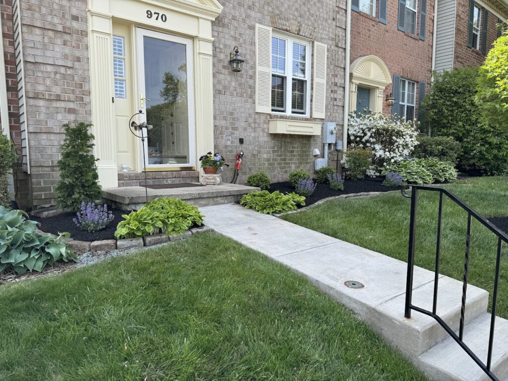 Landscaped front yard with defined beds and mulch