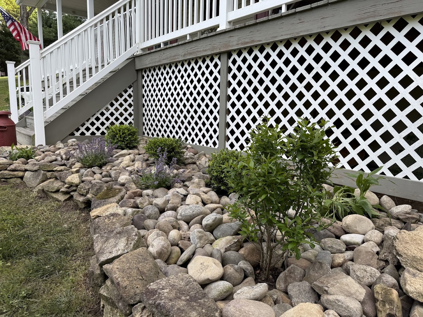 Stone border and river-rock bed moving water away from the house